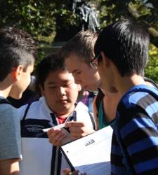 A group of students reading instructions.