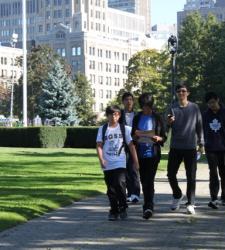 Students walking in a park downtown.