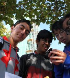 A group of friends looking at a phone.